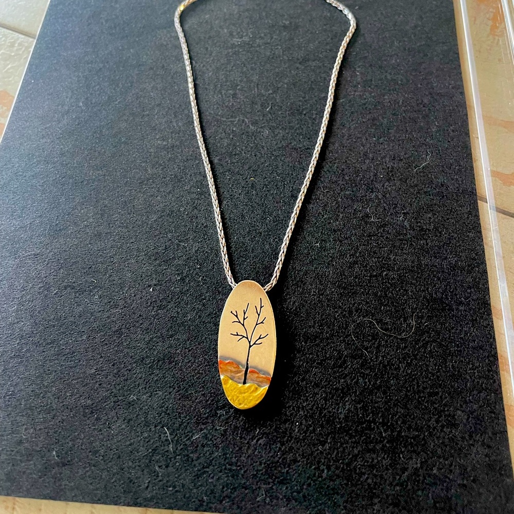 Silver, gold and copper hand engraved pendant.